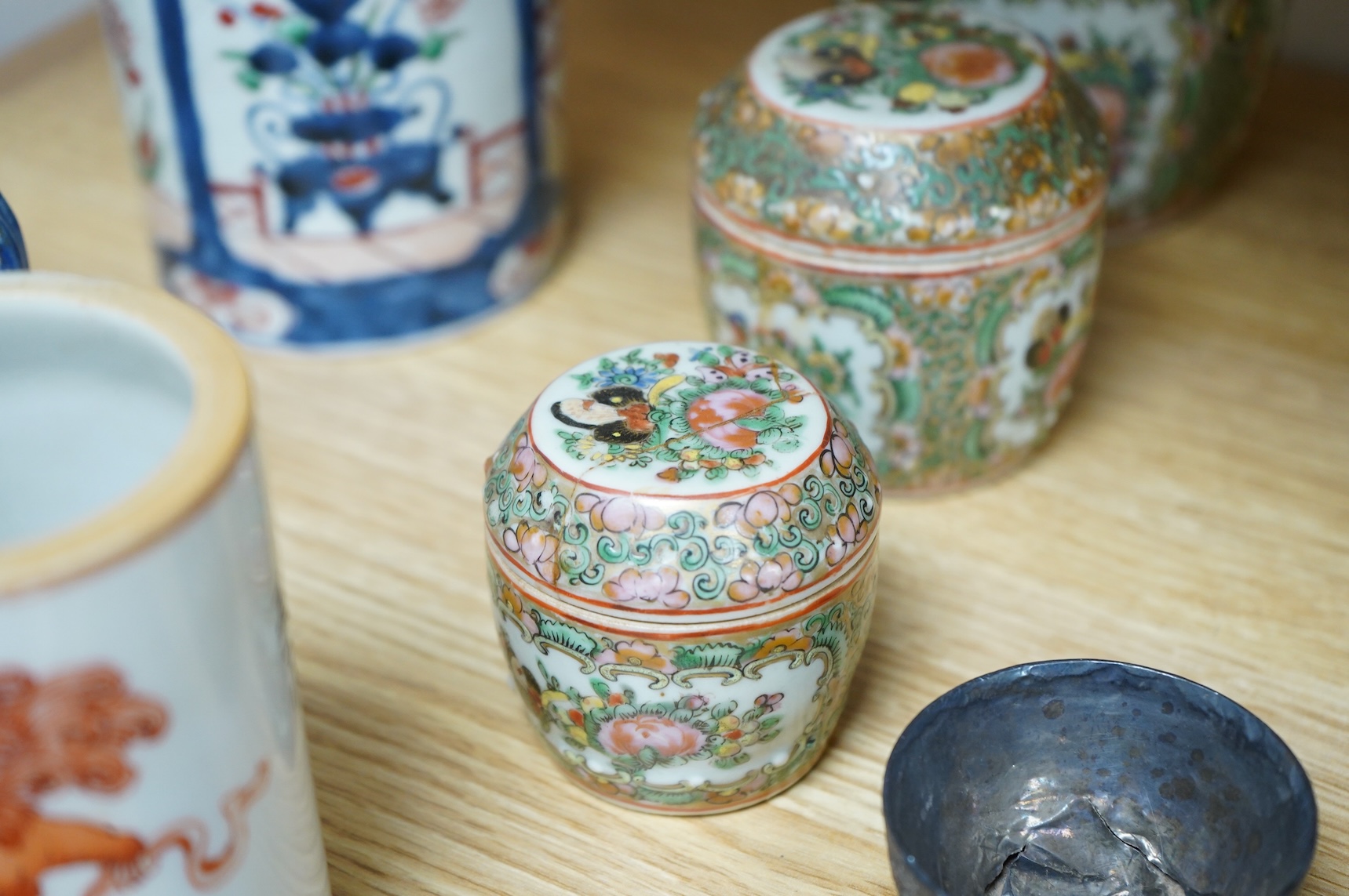 A collection of Chinese ceramics to include a blue and white mug, set of three graduated Canton jars and covers and two cylindrical brush washers
